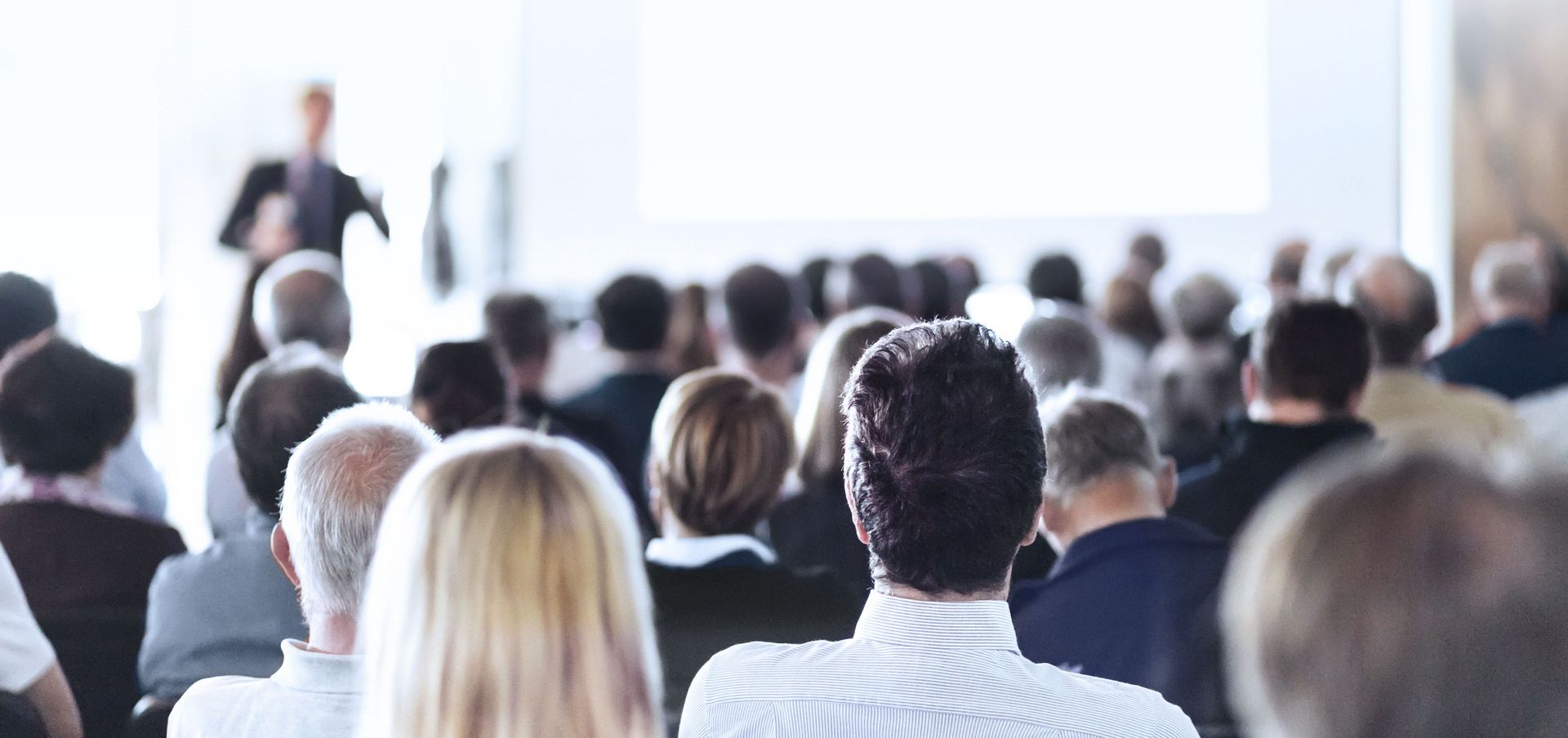 Speaker giving a speech in front of an audience